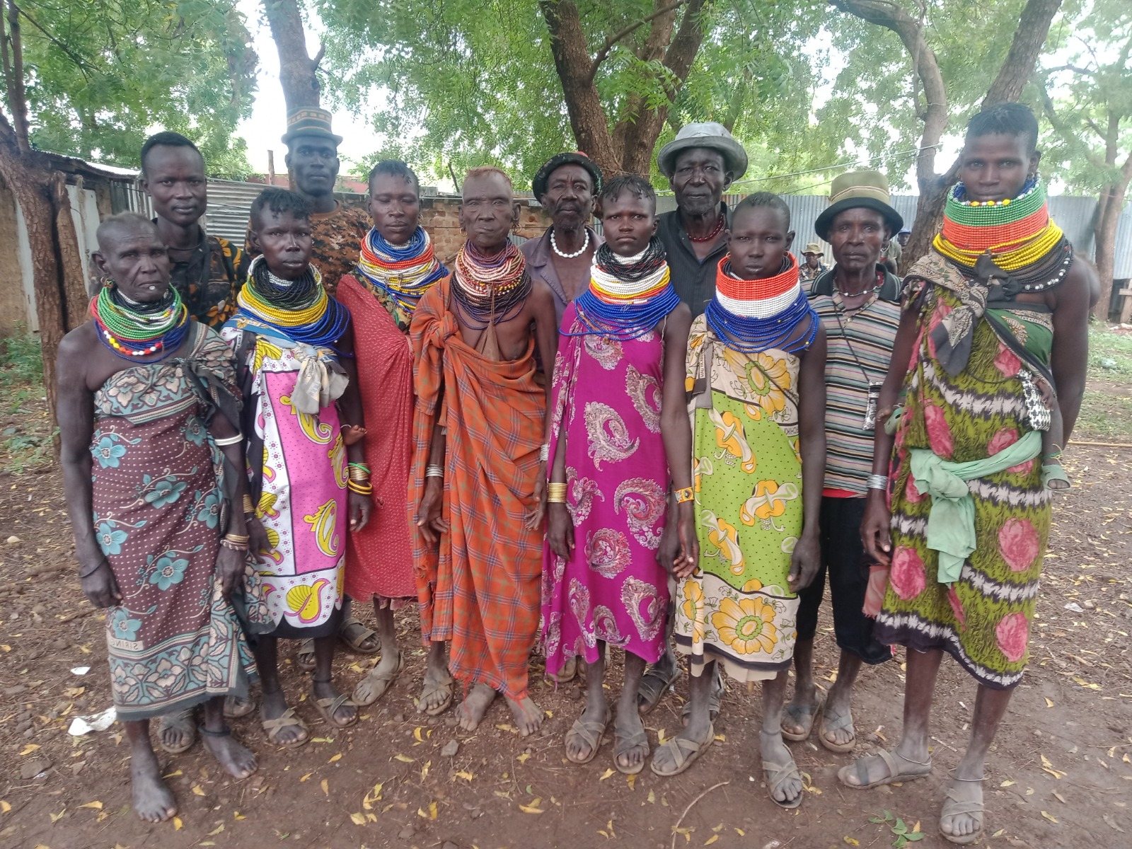 Turkana community members in traditional beadwork and dress gathered outdoors